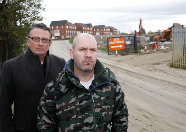 Residents living at Navigation Point housing development say work to complete the remaining houses there is "a nightmare" with mud everywhere. Pictured are Paul Mortimer and Darren Mortimer