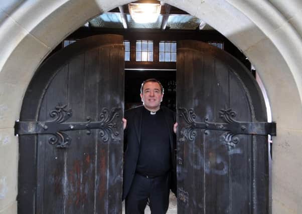 The Very Revd Jonathan Greener, Dean of Wakefield, standing in the new entrance for Wakefield Cathedral.