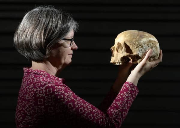 Dr Jane Richardson of the West Yorkshire Archalogical Service with a skull found during the dig in Leeds at the site of Victoria Gate.