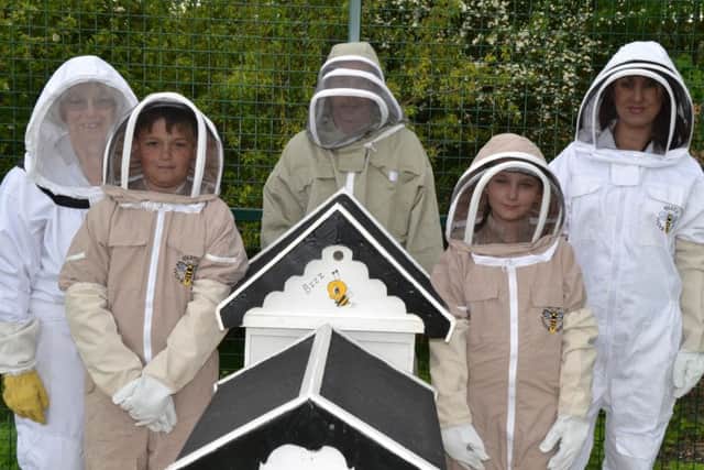 Greenhill Primary School beekeeping project. Pictured are governor Sue Rigby, pupil Jenson Marsden-Milner, parent and beekeeper Craig Baldwin and daughter Paige Baldwin and teaching assistant Victoria Lodge. Picture: Martin Fenton.