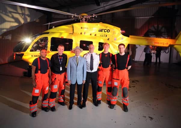 Cpt Andy Lister and his team pictured with Geoffrey Boycott by the new state of the art helicopter. Picture by Simon Hulme.