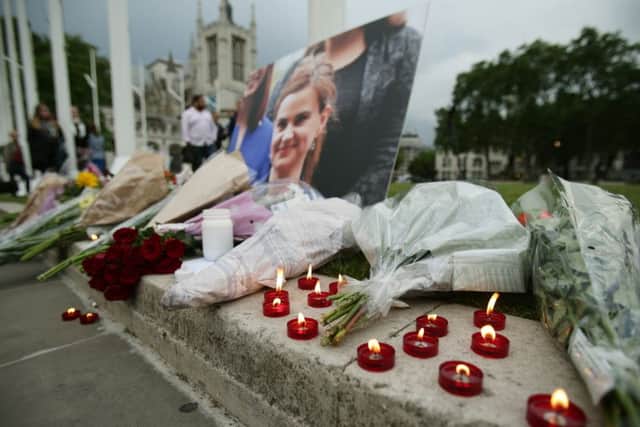 Flowers and candles at Parliament Square opposite the Palace of Westminster in London. Pic: PA.