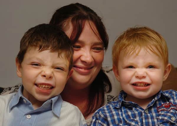 Theresa Barber with sons Luke and Harry.