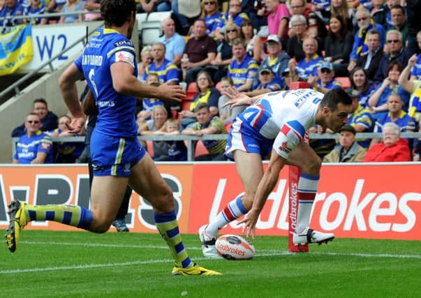 Wakefield's Craig Hall goes over for the first try in Saturday's Challenge Cup semi-final with Warrington. PIC: Jonathan Gawthorpe