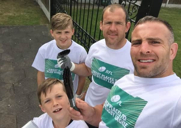 Castleford Tigers' Andy Lynch and Danny Orr with their sons Iwan Orr and Tristen Lynch during a volunteer day at Kippax Welfare.