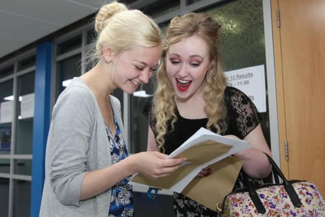 Students read through their results slips to find out their A level results.