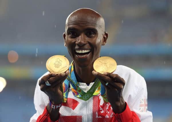 Great Britain's Mo Farah with his gold medals for victory in the Men's 5000m and 10000m. (Picture: PA)