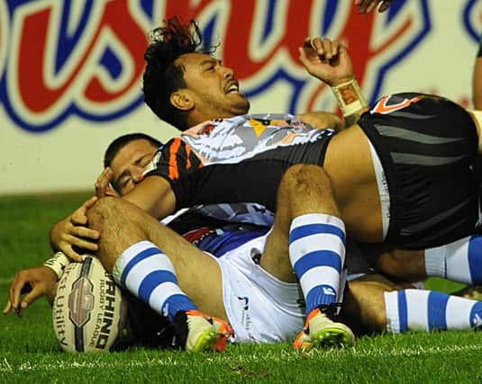 Denny Solomona scores one of his three tries against Wakefield.