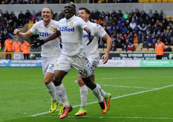 Hadi Sacko celebrates with Luke Ayling and Kalvin Phillips after his cross leads to Leeds United's winning goal at Wolves. Picture : Jonathan Gawthorpe