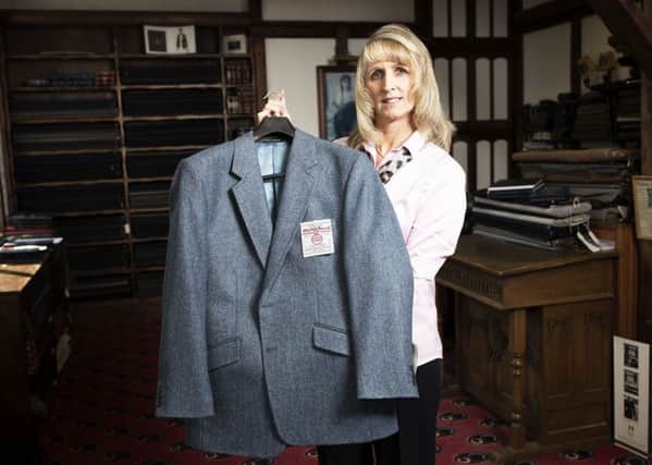 Carl Stuart worker Jill Firth with a Harris Tweed jacket .