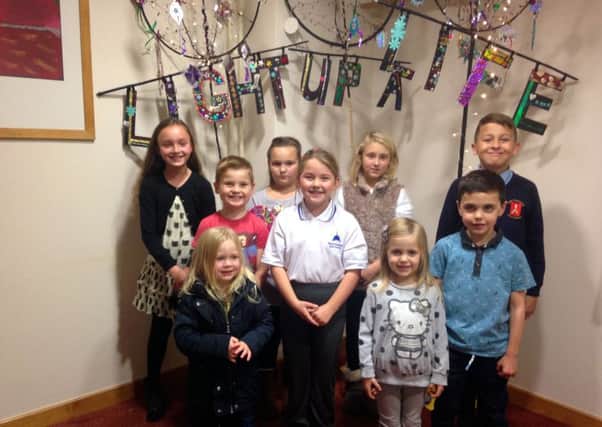 Children with the banner they have made for the Light up a Life services for Wakefield Hospice on December 2 and 4.
