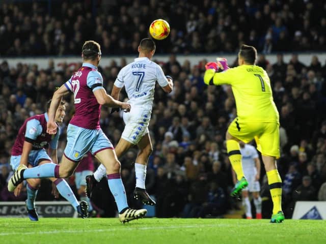 Kemar Roofe heads in his first goal for Leeds United as the Whites beat Aston Villa.