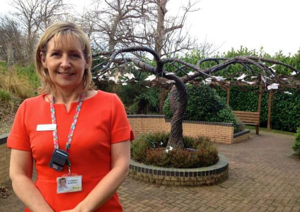 TREE: Wakefield Hospices family care nurse, Cathryn Hartley, in front of the Tree of Life.  Picture: Wakefield Hospice.