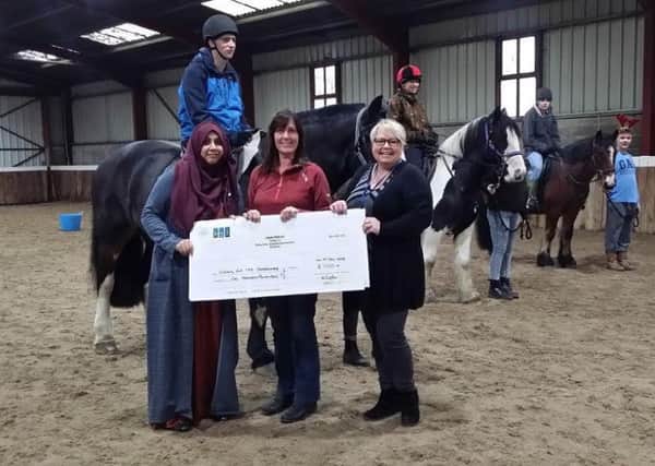 MONEY: Wakefield Riding for the Disableds Carolyn Brown, centre, with  BGLs  Misbah Hussain, left, and Helen Armstrong.
