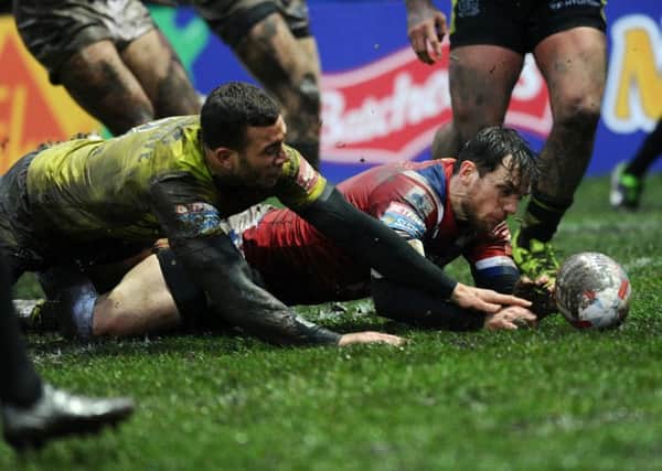 Scott Grix scores the opening try against Hull FC.