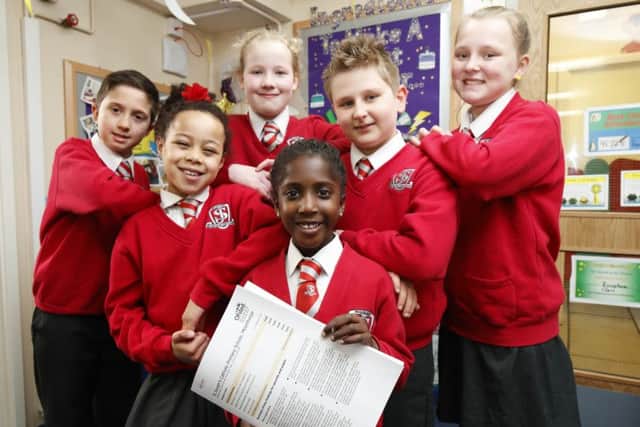Class act: Pupils celebrate their good news from Ofsted.