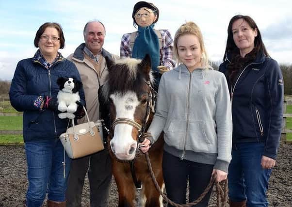 SADDLE UP: Tommy, the horse-riding scarecrow, goes for trot with Cheeky, the smallest of the ponies at Wakefield Riding for the Disabled. He will be raising money for the charity between now and September.