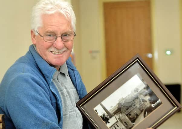 Alan Sykes with a picture of the former mill.