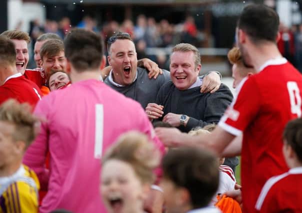 Grant Black and the rest of the Ossett Town squad celebrate securing a place in the play-offs last Saturday. Pic: Mark Gledhill