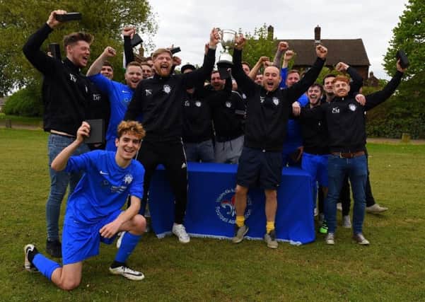 Rock Inn celebrate winning the Wakefield Saturday League's Division One, with captain Jack Nodder (left) and coach Paul Robinson holding the championship trophy aloft. Picture: Matthew Merrick