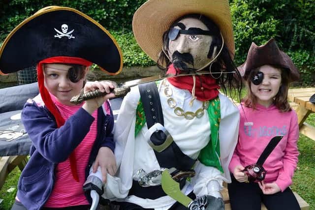 CUTLASSES: The future looked grim for One-Eye Jake in the clutches of these sword wielding pirates at a scarecrow festival coffee morning in Sandal last Saturday. Pictures by Richard Taylor.