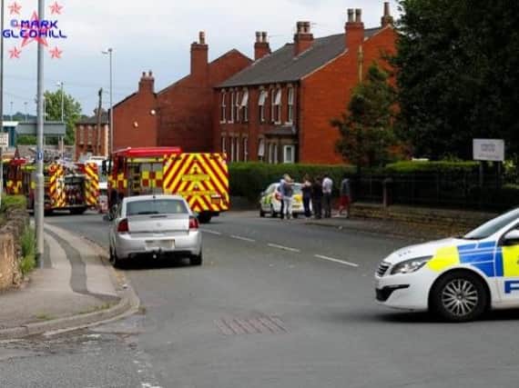 Police block the road while paramedics and firefighters work at the scene. Picture: Mark Gledhill