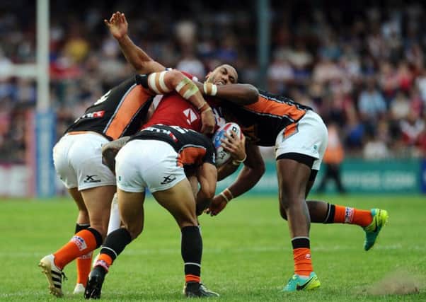 Wakefield's Bill Tupou is tackled by Castleford's Mike McMeeken, Ben Roberts and Gadwin Springer.