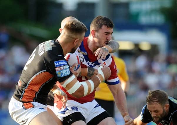 SURROUNDED: Wakefield's Adam Walker is tackled by Castleford's Nathan Massey, Mike McMeeken and Paul McShane.
 Picture: Jonathan Gawthorpe
