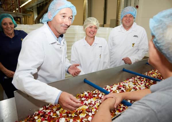 PRODUCTION LINE: Yvette Cooper, centre, sees how Haribo makes its sweets. Managing director Herwig Vennekens, right, looks on.