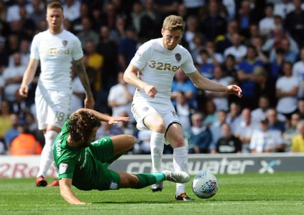 Ben Pearson lunges in on Eunan O'Kane to earn the first of his two yellow cards for Preston at Leeds United. Picture: Jonathan Gawthorpe