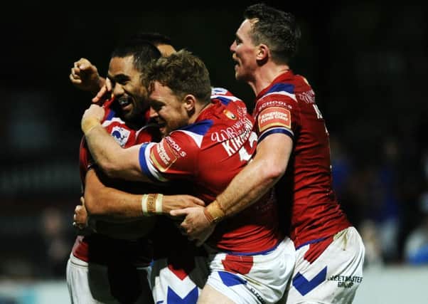 Bill Tupou, left, is congratulated by team-mates after scoring against Leeds Rhinos.
