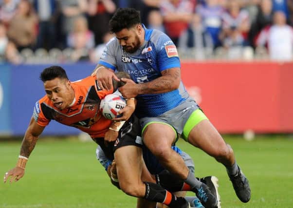 Castleford's Ben Roberts is tackled by Wakefield's David Fifita. Picture: Jonathan Gawthorpe