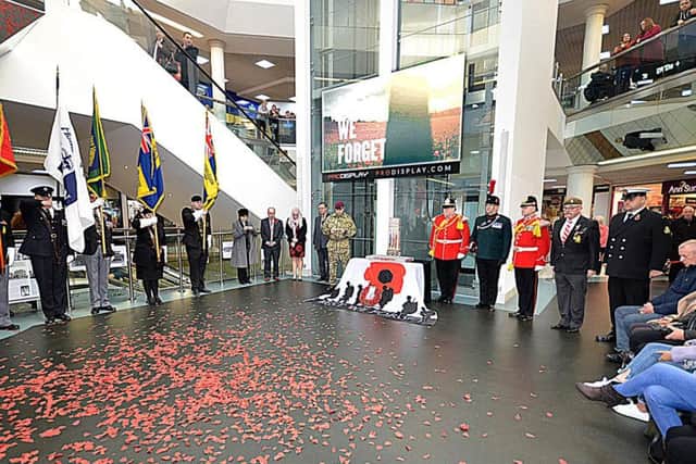 Poppies rest on the floor at the end of the Armistice Day service at The Ridings.
