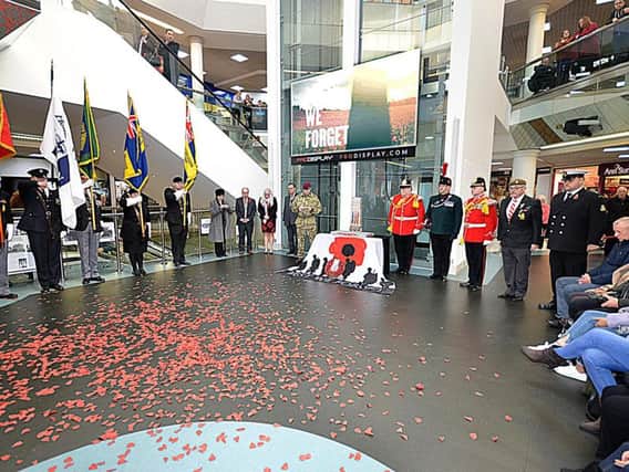 Poppies rest on the floor at the end of the Armistice Day service at The Ridings.