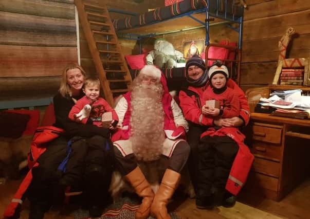 ALL SMILES: Freddie McDonald and his family meet Santa Claus in Lapland.