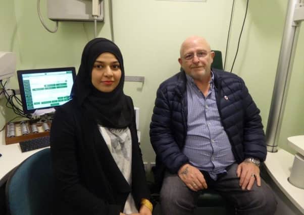 EYE TEST: Optometrist Anim Razzak, left, with customer Brian Mynott whose sight she helped to save.