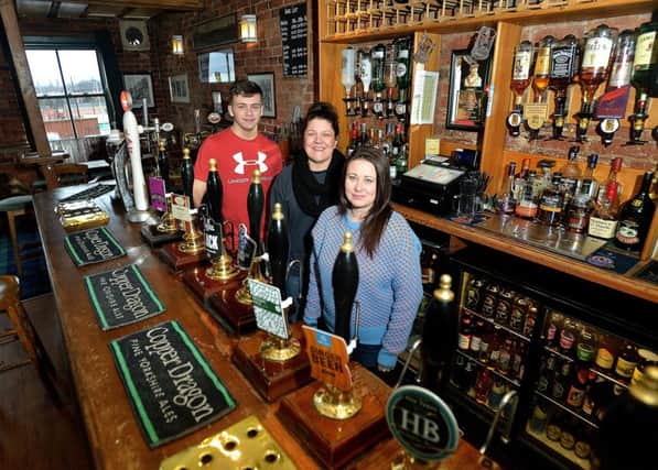 Cheers: Staff Jack Messenger, Louise Waters and Lou Clarke at Harrys Bar.