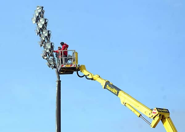 23 Jan 2018......... Workmen carry out maintenance on the floodlights high above Wakefield Trinity's Belle Vue ground ahead of the up-coming Rugby Super League season. Picture Scott Merrylees