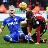 Leeds United's Gianni Alioski feels the pain after being fouled by Sheffield United's Lee Evans. Picture: Jonathan Gawthorpe