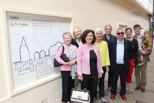 Mosaics designed by local artist Fiona Oberon to brighten up Almshouse Lane.