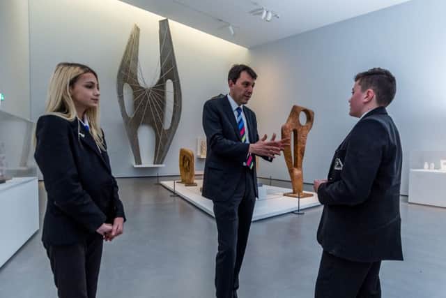 John Glen MP, Minister for Arts, Heritage and Tourism, chatting with two Year 9 students Roksana Maciejewska and Nathan Allen, from Cathedral Academy in Wakefield, about their role as Art Ambassadors at The Hepworth Gallery, Wakefield.