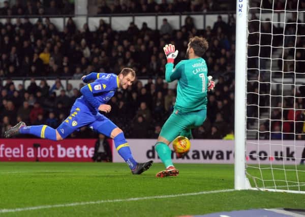 Pierre-Michel Lasogga heads the ball past Derby keeper Scott Carson to score Leeds United's opening goal.  Picture: Tony Johnson.