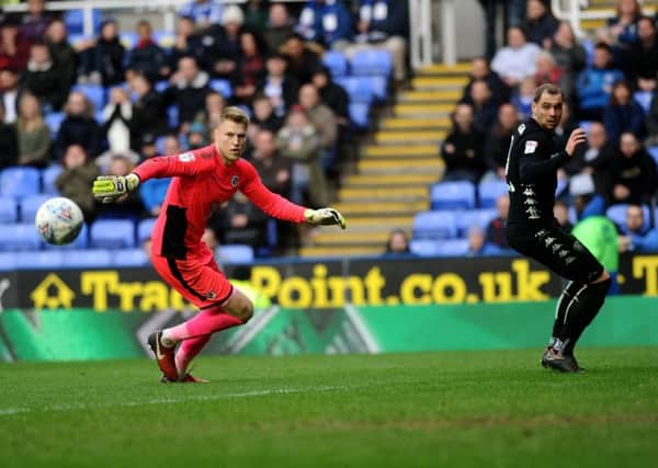 Pierre-Michel Lasogga watches after his charge down of Reading keeper Anssi Jaakkola's kick hits the post. Picture: Jonathan Gawthorpe