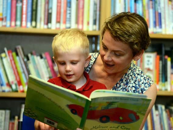 Pontefract, Castleford and Normanton MP Yvette Cooper reads to a child at Airedale Library.