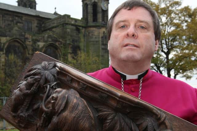 The Bishop of Wakefield Tony Robinson, then Bishop of Pontefract, pictured with one of the misericords in 2012.