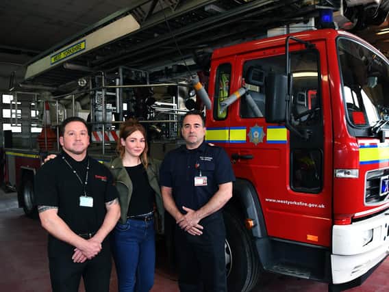 Lou Evans, who was rescued from the River Aire and reunited with the fire crews from Leeds Fire Station, who saved her life. She is pictured with Richard Goc, who raised the alarm and firefighter Andrew Sharp, who went in the river to save her.