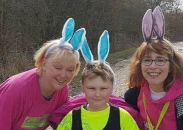 Lewis Batey, with his mum Michele Wilson and a Candlelighters volunteer.