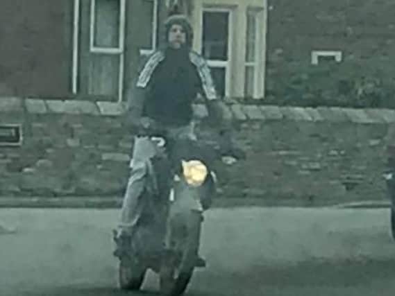 Police want to identify this man after a biker was seen doing wheelies in front of other cars.