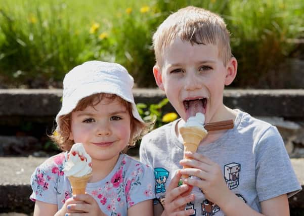 Millie and Joshua Simpson cool down with an ice cream.