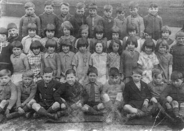 The boys and girls of class 2, Wheldon Lane School, Castleford, in 1929, gathered in the school playground. Taken 1929